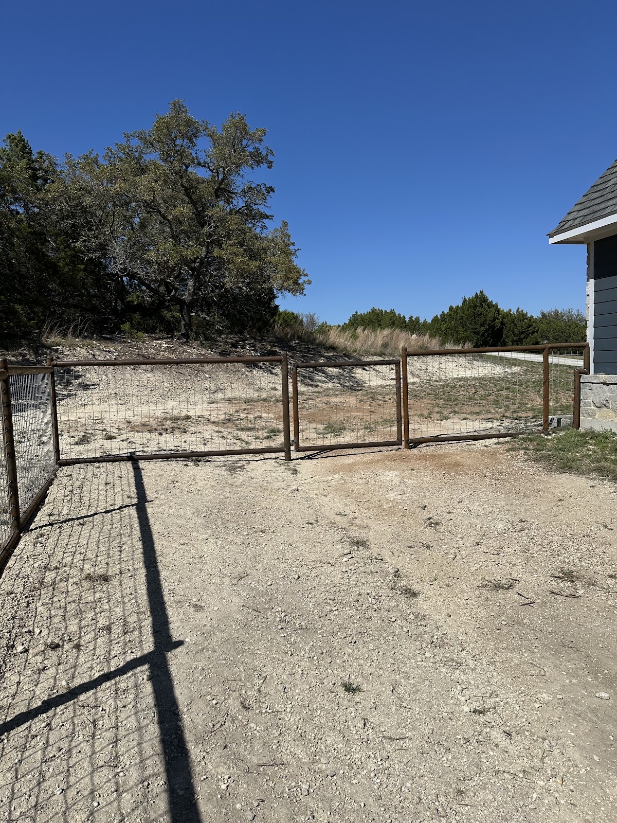 Custom metal gate at rural property entrance